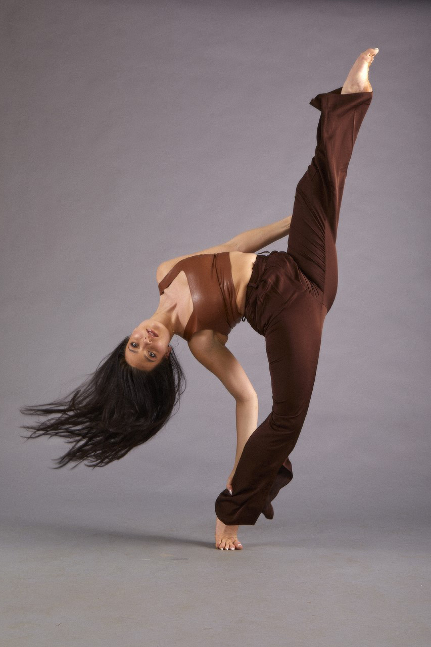 A female dancer with her leg extended in a high split